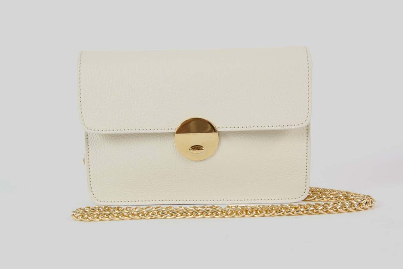 Small offwhite handbag with a golden strap.