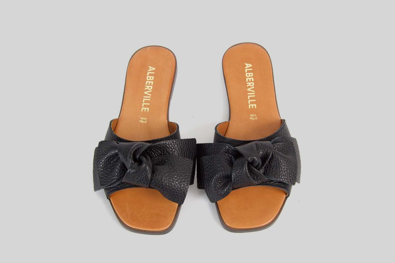 Black open toe sandal with a bow.