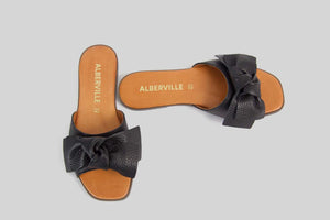 Black open toe sandal with a bow.