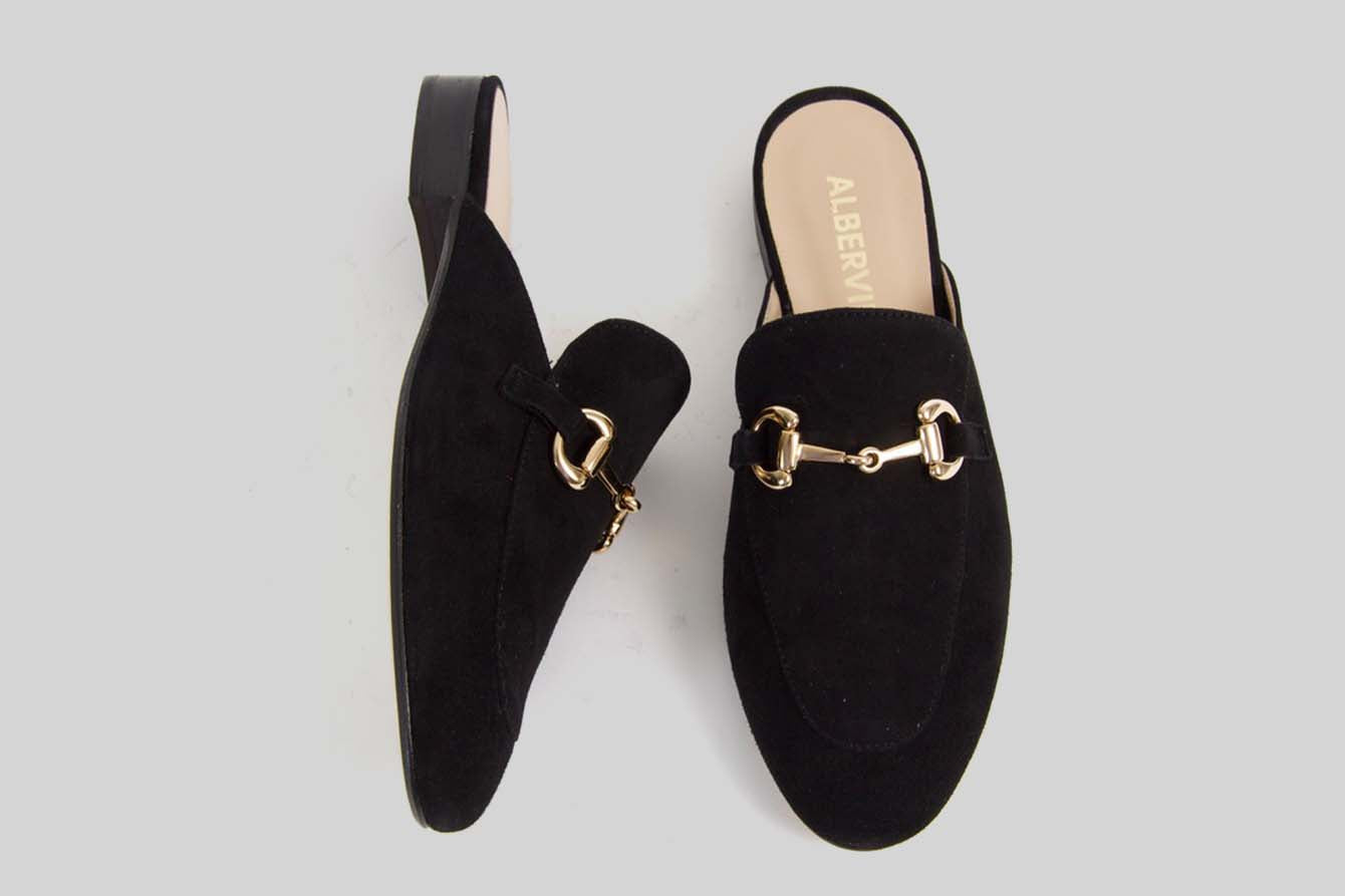 Black slipon loafer made in calf suede with a golden buckle.