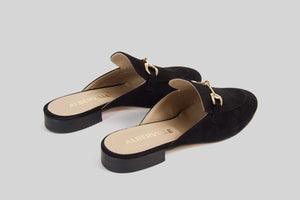 Black slipon loafer made in calf suede with a golden buckle.