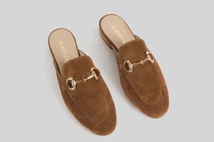 Nougat brown slipon loafer with a golden buckle.